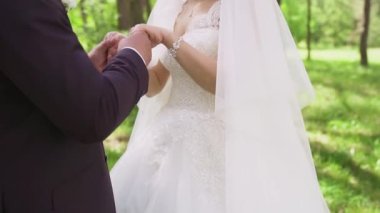 Hot man showing tenderness woman in garden. Portrait of sexy couple expressing feelings in park. Close up gorgeous bride and groom kissing on wedding ceremony outdoors. High quality FullHD footage