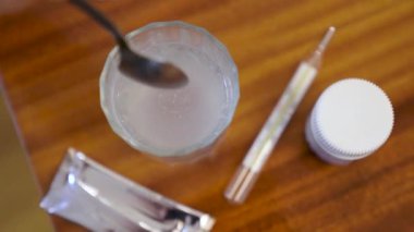 View footage of Medicine powder falling to water swirl in glass, Slow motion. High quality 4k footage