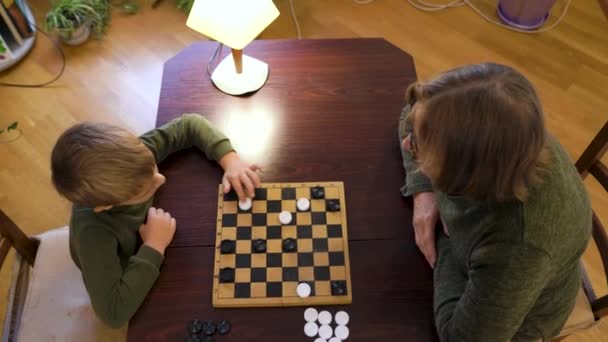 Happy Little Boy Playing Checkers Senior Woman Home Family Relationship — Video Stock