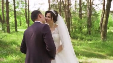 Hot man showing tenderness woman in garden. Portrait of sexy couple expressing feelings in park. Close up gorgeous bride and groom kissing on wedding ceremony outdoors. High quality FullHD footage