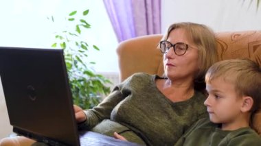 Grandson showing grandparents how to use computer. High quality 4k footage