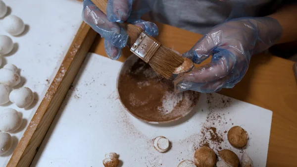 stock image The confectioner dusts the handmade champignons of marshmallow with cocoa powder. Home business concept. High quality 4k footage