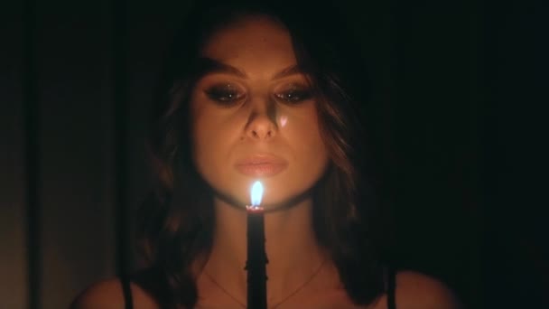 Frau Bläst Kerze Vor Schwarzem Hintergrund Und Verschwindet Der Dunkelheit — Stockvideo