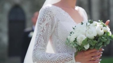 Düğün günlerinde genç bir çift. Damat kalenin yanındaki geline yaklaşıyor. Şefkat anı. Yüksek kaliteli FullHD görüntüler