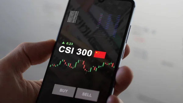 stock image August 7th 2023, Someone looks the index stock exchange-traded fund etf chart on a phone. Business analysis of a trend, to invest in CSI 300 ETF. Buying strategic Shanghai and Shenzhen blue chips.