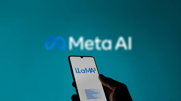 Someone looking the page of LlaMa 2 on a phone, in a background the blurry logo of Meta AI.