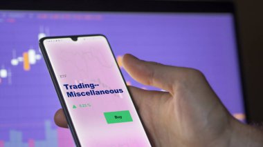 Ticareti analiz eden bir yatırımcı. Ekrandaki çeşitli etf fonu. Bir telefon alım satım fiyatlarını gösterir - Çeşitli