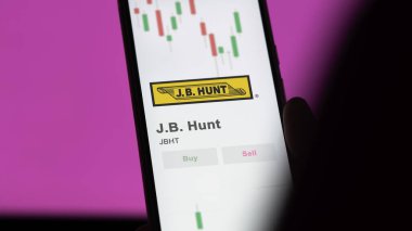 Takas ekranında J.B. Hunt 'ın logosu. J B Hunt hisse senetleri, bir cihazda JBHT $.
