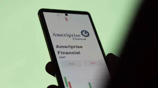 stock image The logo of Ameriprise Financial on the screen of an exchange. Ameriprise Financial price stocks, $AMP on a device.