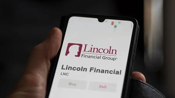 Stock image The logo of Lincoln Financial on the screen of an exchange. Lincoln Financial price stocks, $LNC on a device.