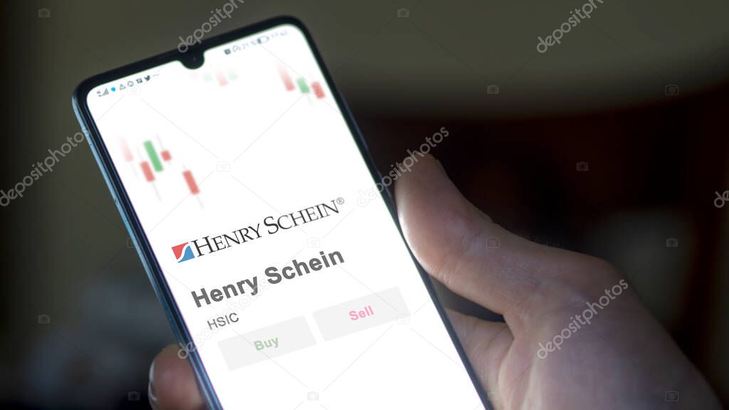 The logo of Henry Schein on the screen of an exchange. Henry Schein price stocks, $HSIC on a device.