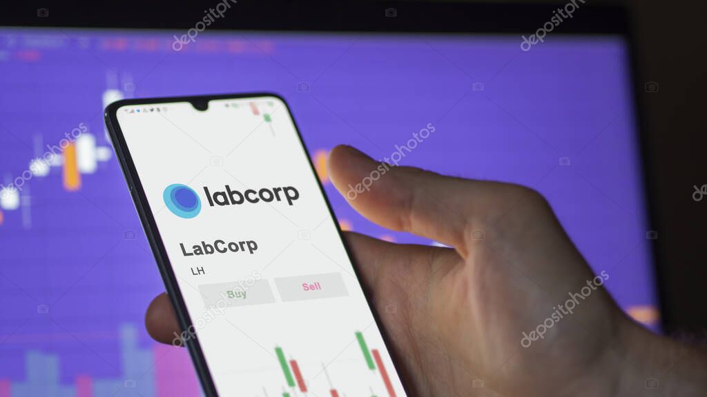 The logo of LabCorp on the screen of an exchange. LabCorp price stocks, $LH on a device.