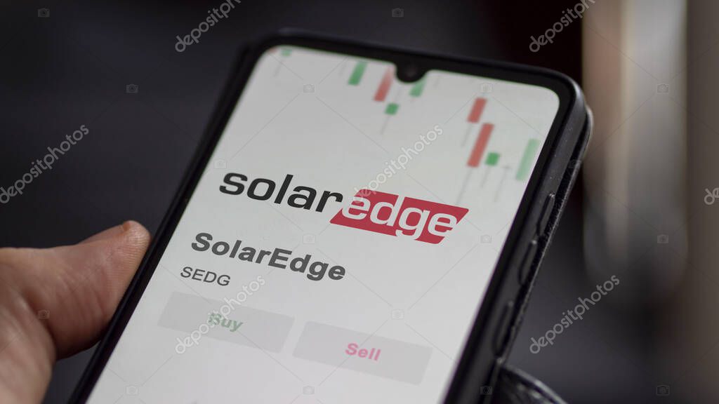 The logo of SolarEdge on the screen of an exchange. SolarEdge price stocks, $SEDG on a device.