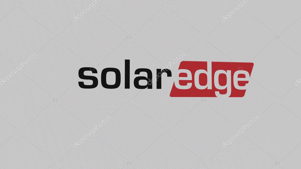 The logo of SolarEdge on a white wall of screens. SolarEdge brand on a device.