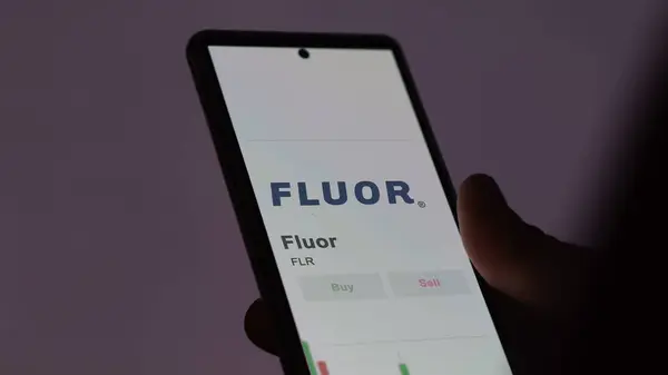 Stock image The trading page of Fluor on a stock exchange, a shareholder analyzing $FLR, Fluor, on a device.