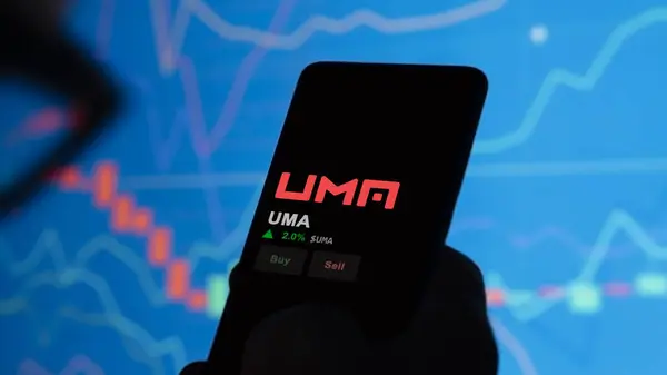 stock image November 24th 2023. An investor analyzing the price of UMA on a phone, the token coin $UMA on a crypto exchange sreen.