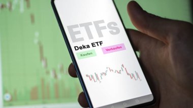 Aralık 2022. Bir yatırımcı Deka ETF fonunu telefon ekranında analiz eder. Almanca metin: Kaufen, Verkaufen, Deka ETF satın al, sat, Deca ETF