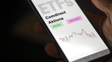 Aralık 2022. Bir yatırımcı, telefon ekranında doğrudan Aktions-ETF 'lerde ETF fonunu analiz eder. Almanca metin: Kaufen, Verkaufen, comdirect Aktions buy, sell, comdirect campaign