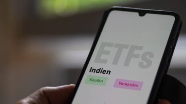 Aralık 2022. Bir yatırımcı Hindistan ETF fonunu telefon ekranı Indien-ETF 'lerde analiz ediyor. Almanca çeviri: Kaufen, Verkaufen, Indien buy, sell, India