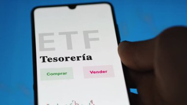 Etf fonunu analiz eden bir yatırımcı. İspanyolca ETF metni: hazine, satın al, sat.