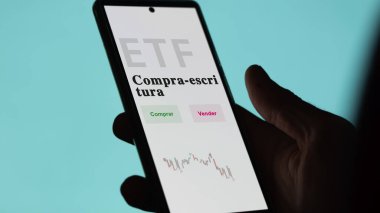 Etf fonunu analiz eden bir yatırımcı. İspanyolca ETF metni: al-yaz, satın al, sat.