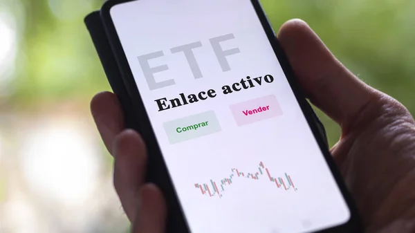 stock image An investor analyzing an etf fund. ETF text in Spanish : Active Bond, buy, sell.