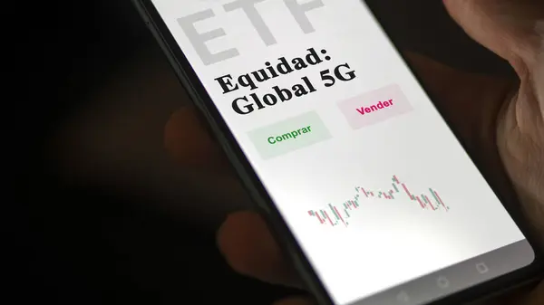 stock image An investor analyzing an etf fund. ETF text in Spanish : Equity: Global 5G, buy, sell.