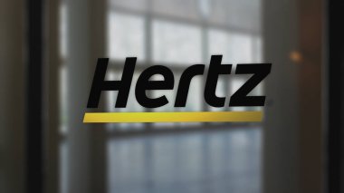 20 Kasım 2023. Hertz 'ün logosu bir iş bölgesindeki bir salonun camında...