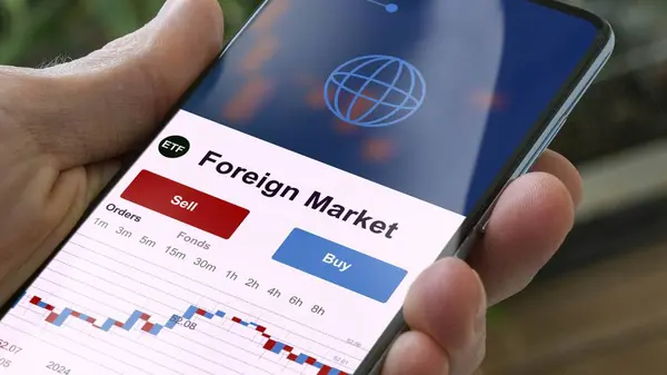 Exchange-traded fund chart, invest in stock market data on smartphone of foreign market. Business analysis of a trend. Investing in international funds. Buying blue chips foreign markets strategic ETF