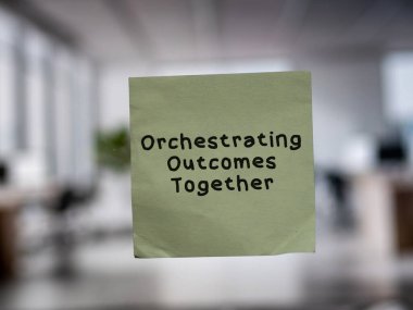 Post note on glass with 'Orchestrating Outcomes Together'. clipart