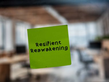 Post note on glass with 'Resilient Reawakening'. clipart
