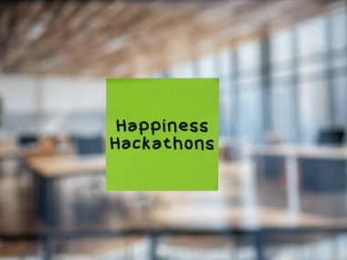 Post note on glass with 'Happiness Hackathons'. clipart