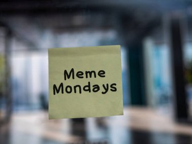 Post note on glass with 'Meme Mondays'. clipart