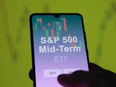 S & p 500 orta vadeli etf fonunu ekranda analiz eden bir yatırımcı. S & P 500 Orta Dönem fiyatlarını gösteren bir telefon