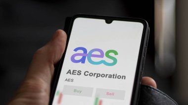 April 04th 2024. The logo of AES Corporation on the screen of an exchange. AES Corporation price stocks, $AES on a device. clipart