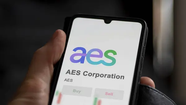 stock image April 04th 2024. The logo of AES Corporation on the screen of an exchange. AES Corporation price stocks, $AES on a device.