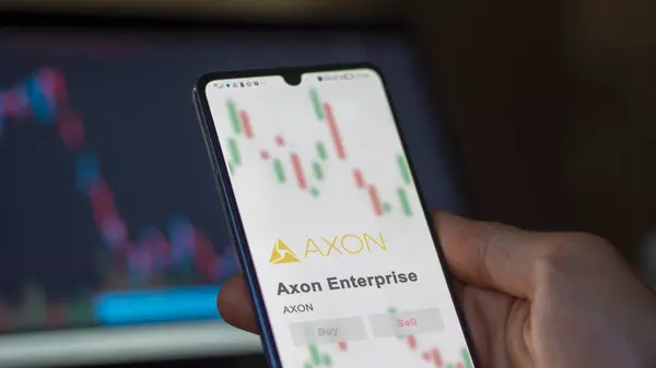 stock image April 04th 2024. The logo of Axon Enterprise on the screen of an exchange. Axon Enterprise price stocks, $AXON on a device.