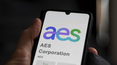 April 04th 2024. The logo of AES Corporation on the screen of an exchange. AES Corporation price stocks, $AES on a device. clipart