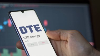April 04th 2024. The logo of DTE Energy on the screen of an exchange. DTE Energy price stocks, $DTE on a device. clipart