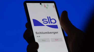 April 04th 2024. The logo of Schlumberger on the screen of an exchange. Schlumberger price stocks, $SLB on a device. clipart