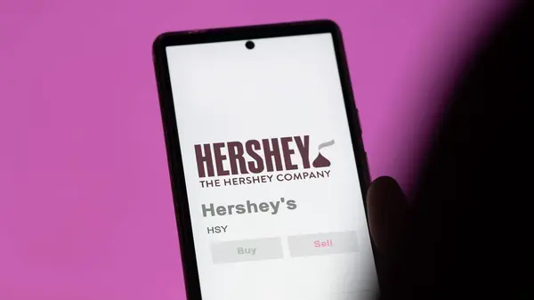 stock image April 04th 2024. The logo of Hershey's on the screen of an exchange. Hershey's price stocks, $HSY on a device.