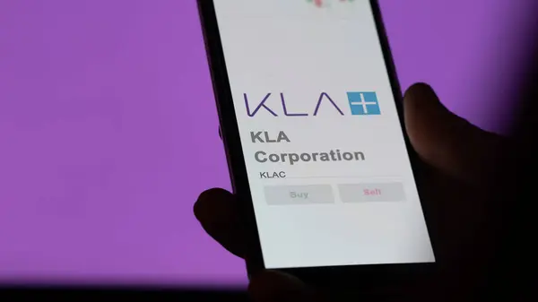 stock image April 04th 2024. The logo of KLA Corporation on the screen of an exchange. KLA Corporation price stocks, $KLAC on a device.