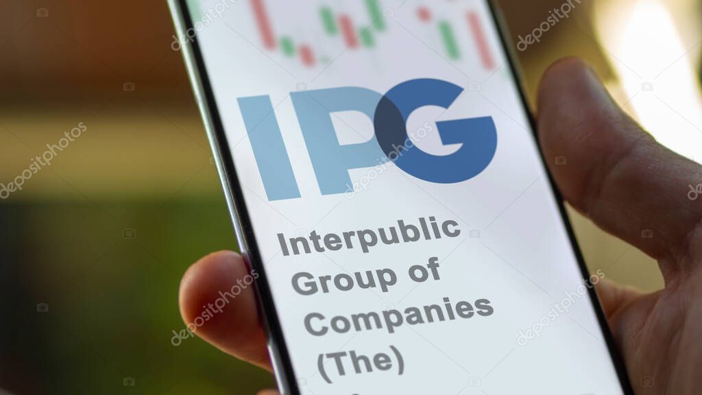 April 04th 2024. The logo of Interpublic Group of Companies (The) on the screen of an exchange. Interpublic Group of Companies (The) price stocks, $IPG on a device.