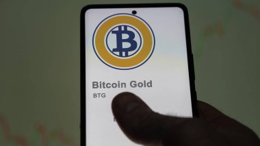 April 17th 2024 , Shanghai, China. Close up on logo of (BTG) Bitcoin Gold on the screen of an exchange. (BTG) Bitcoin Gold price stocks, $BTG on a device. clipart