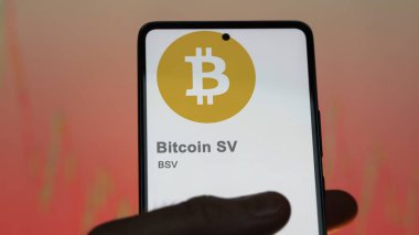 Bir takas ekranında (BSV) Bitcoin SV logosunu kapatın. (BSV) Bitcoin SV fiyat hisseleri, bir aygıt üzerinde $BSV.