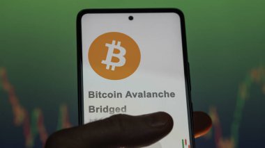 Close up on logo of (BTC.b) Bitcoin Avalanche Bridged on the screen of an exchange. (BTC b) Bitcoin Avalanche Bridged price stocks, $BTC.b on a device. clipart