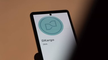 Close up on logo of (DKA) dKargo on the screen of an exchange. (DKA) dKargo price stocks, $DKA on a device. clipart