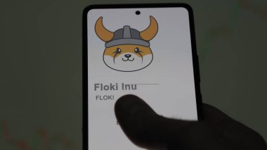 Takas ekranındaki Floki Inu 'nun logosuna yaklaş. Floki Inu hisse senetleri, bir cihazda FLOKI $.