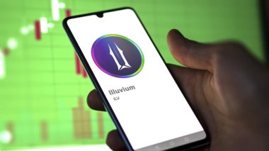 Bir değiş tokuş ekranındaki Illuvium logosuna yaklaş. Illuvium fiyat hisseleri, bir aygıt için ILV $.