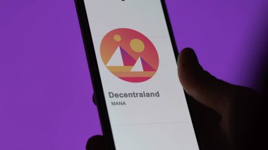 Close up on logo of (MANA) decentraland on the screen of an exchange. (MANA) decentraland price stocks, $MANA on a device. clipart